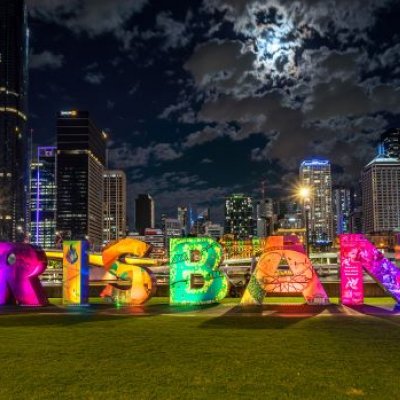 Large block letters placed on a grass patch, reading the name "Brisbane."